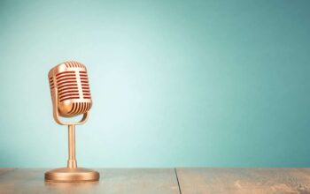 Retro,Golden,Microphone,For,Press,Conference,Or,Interview,On,Table